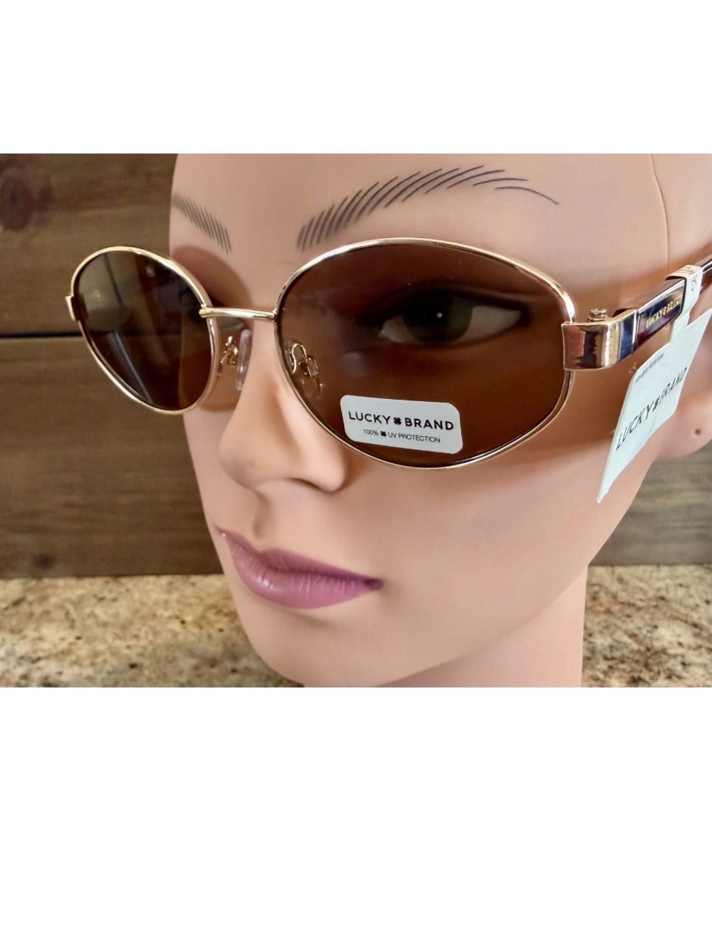 Lucky Brand sunglasses feature a retro gold-tone metal frame & brown lenses.
